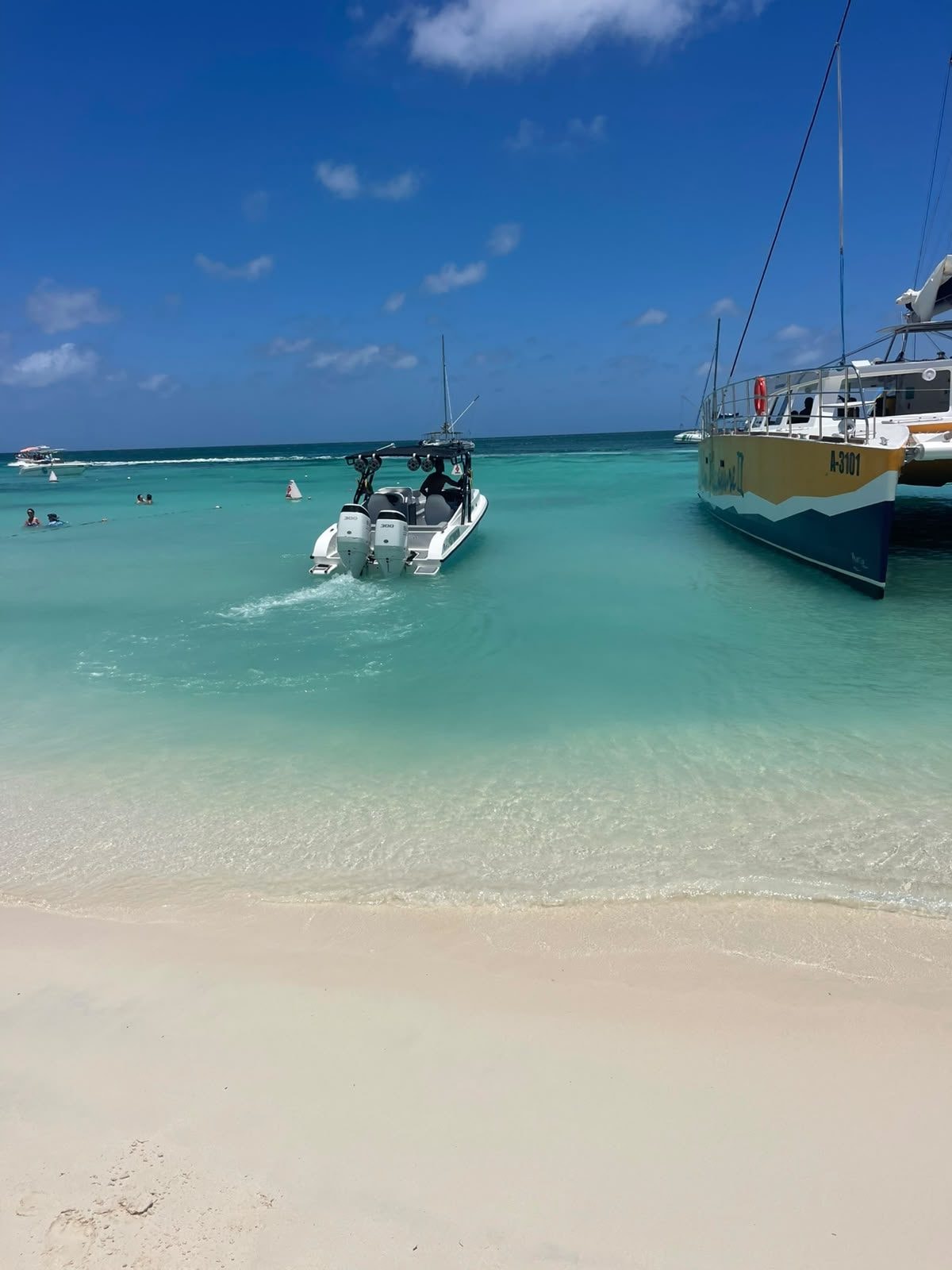 The Aruban Breeze boat waiting in shallow water off the beach