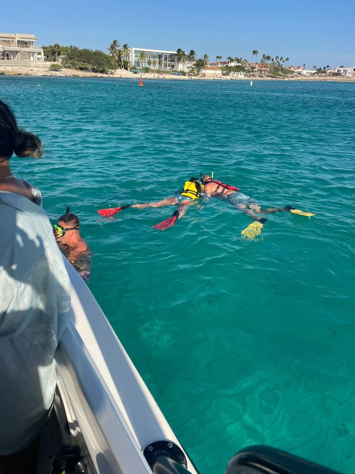 Guests snorkeling next to the Aruban Breeze boat